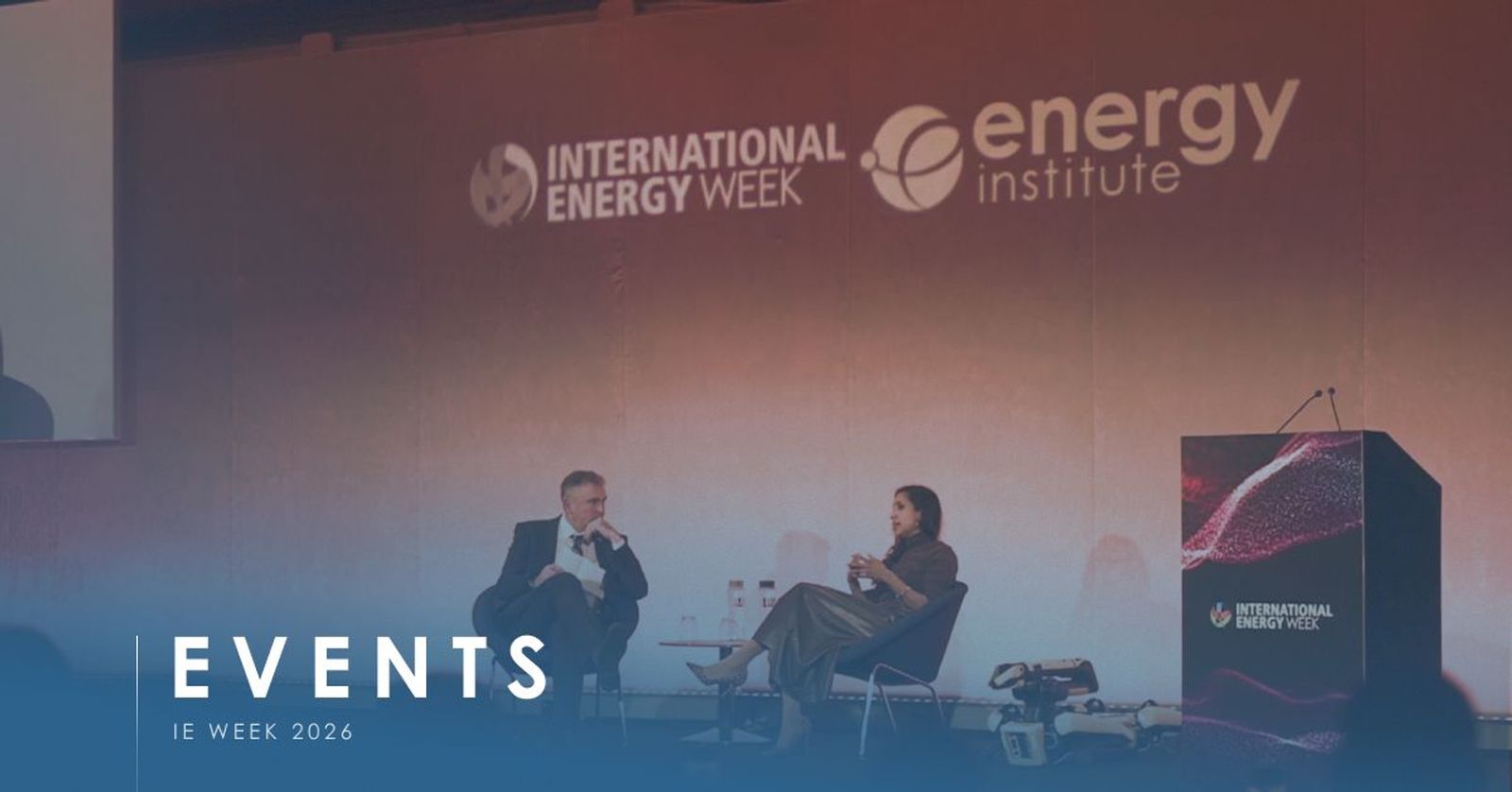 Two speakers on stage in London under the International Energy Week and Energy Institute backdrop